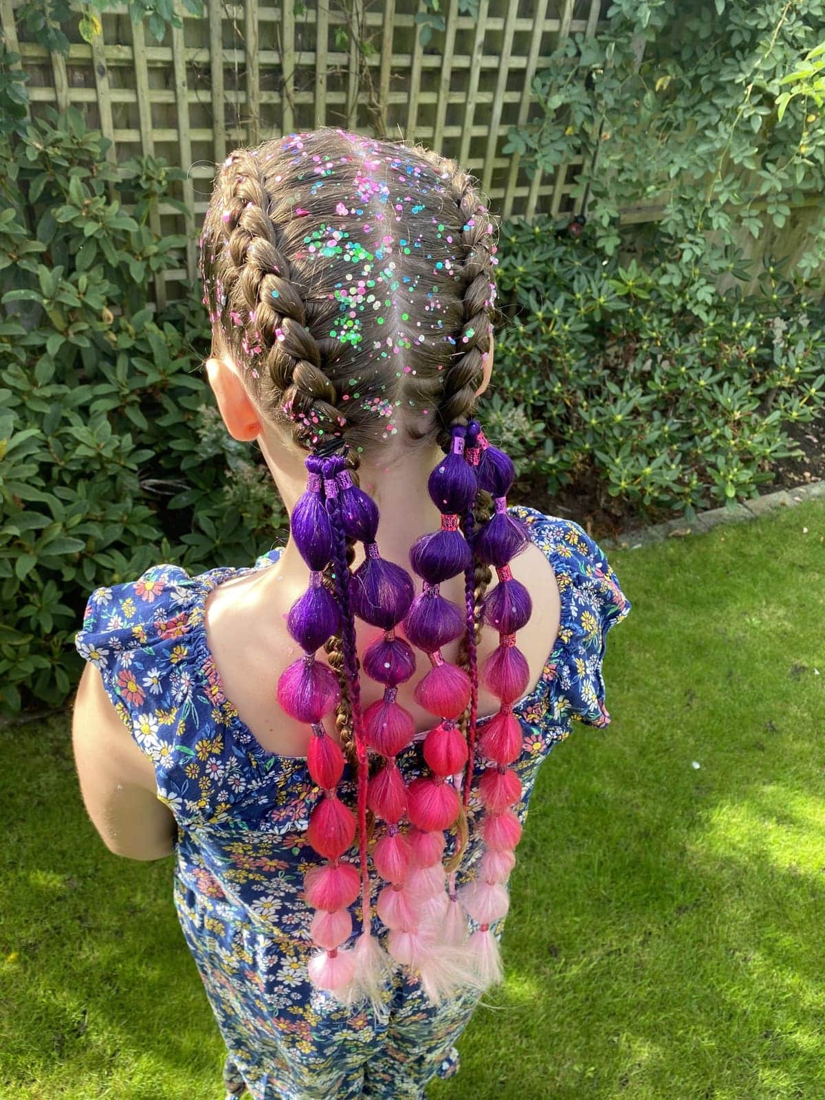 Bubble braids with pink and purple hair pieces and glitter